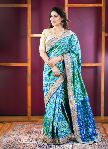 Rama And Blue Embroidered Patola Silk Saree